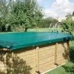 Green debris cover for above-ground pool. Waterproof tarp protects from leaves, dirt. Durable pool safety cover.