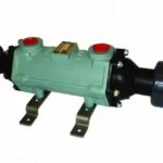 Green metal industrial plumbing component with black plastic fittings.