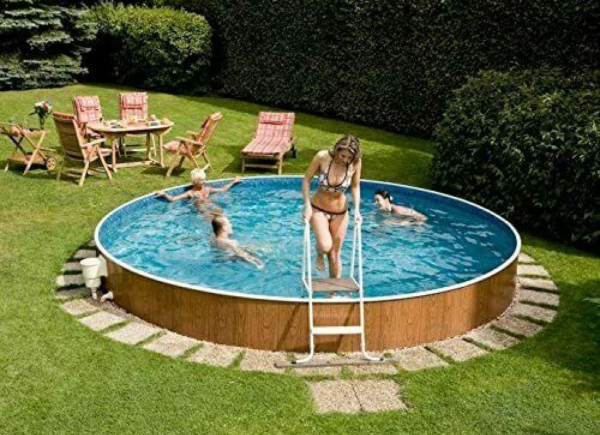 Kids playing in a blue-line swimming pool in a garden.