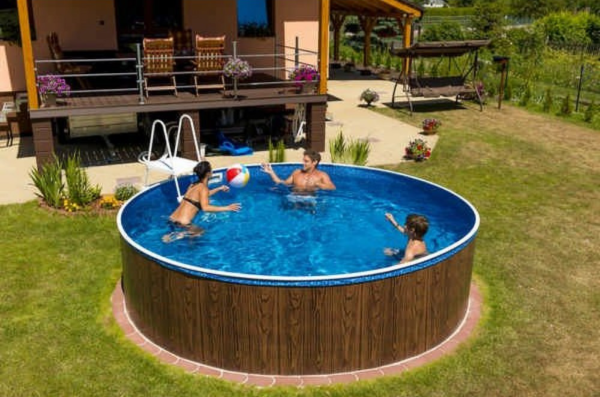 A blu-line swimming pool with adults swimming in it.